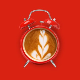 Image of Bright alarm clock with coffee instead of dial on red background, top view