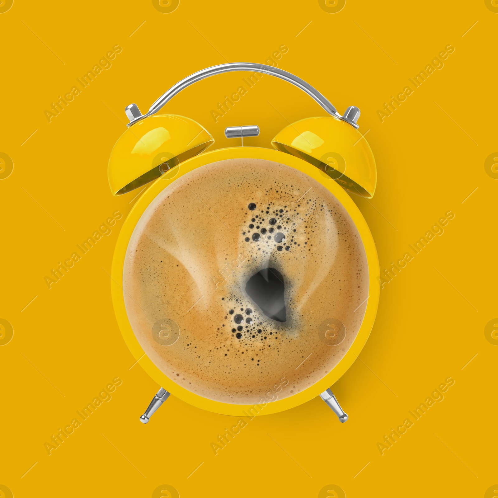 Image of Bright alarm clock with coffee instead of dial on yellow background, top view