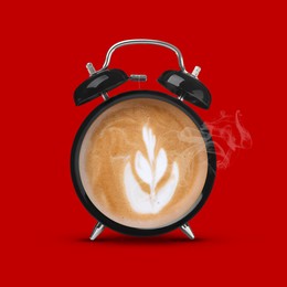 Image of Black alarm clock with coffee instead of dial on red background