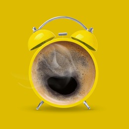 Image of Bright alarm clock with coffee instead of dial on yellow background