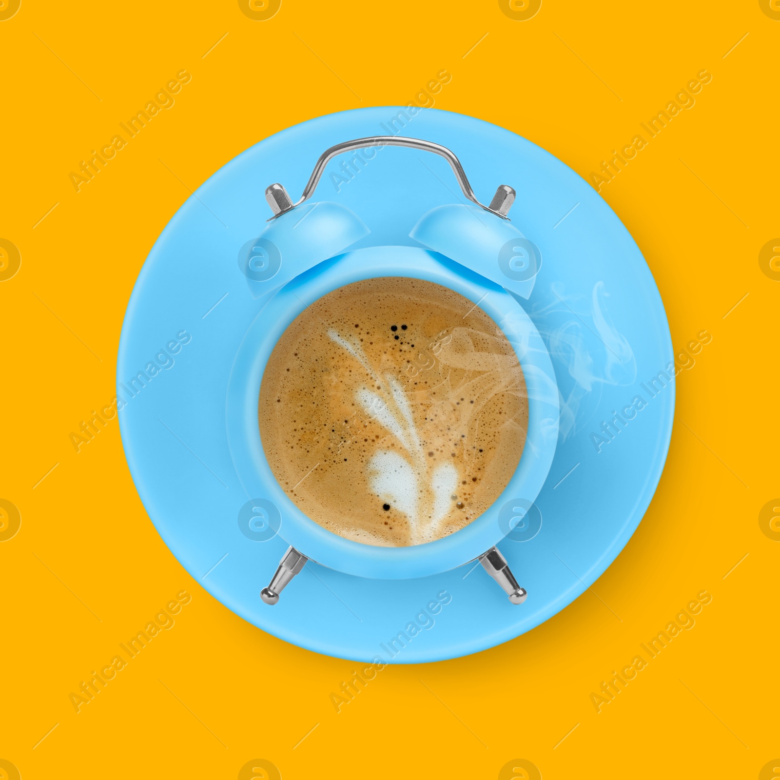 Image of Light blue alarm clock with coffee instead of dial on golden background, top view