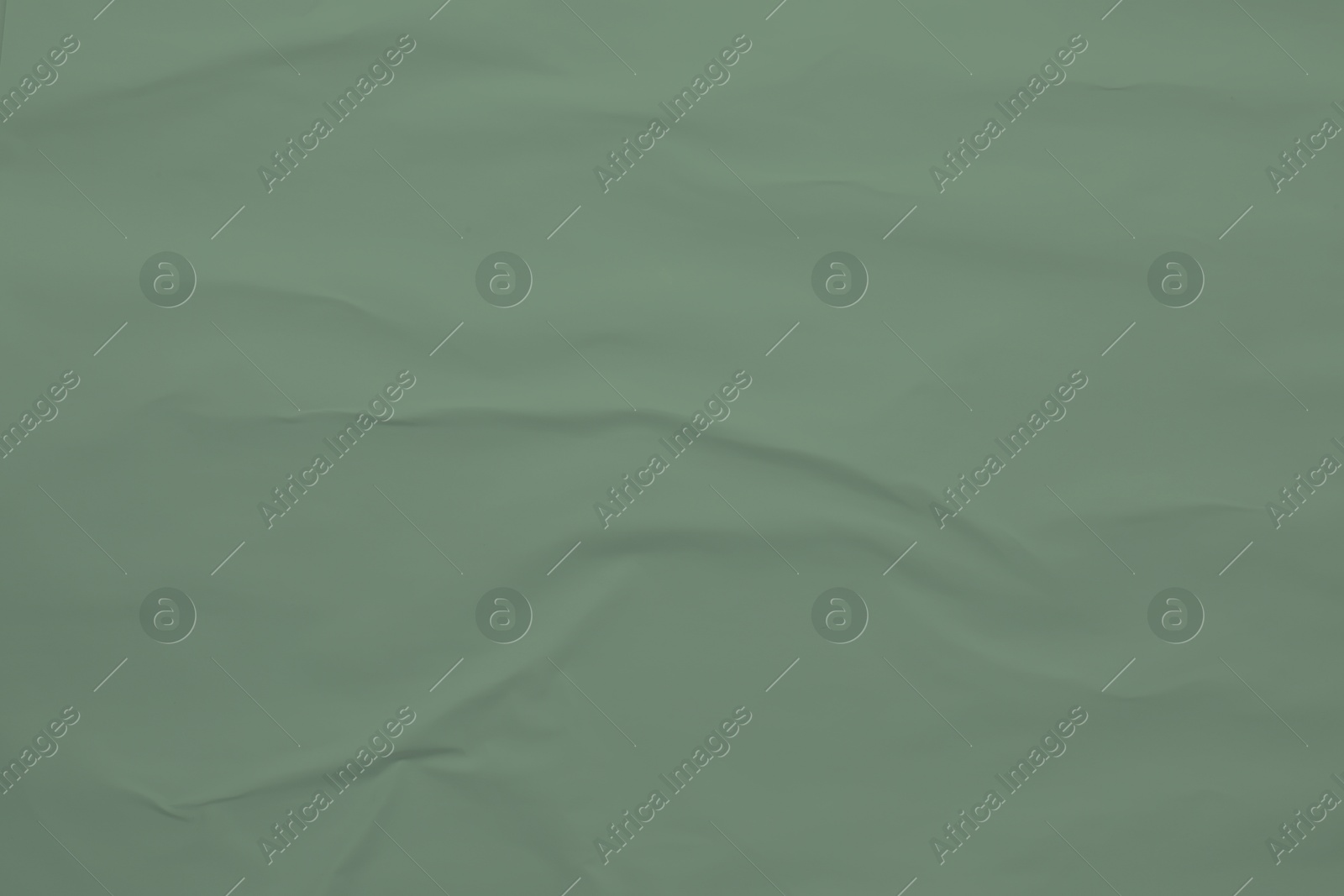 Image of Crumpled sage color sheet of paper as background, closeup