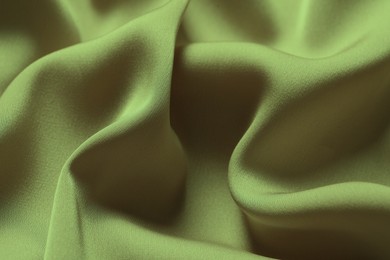 Image of Crumpled sage color silk fabric as background, closeup