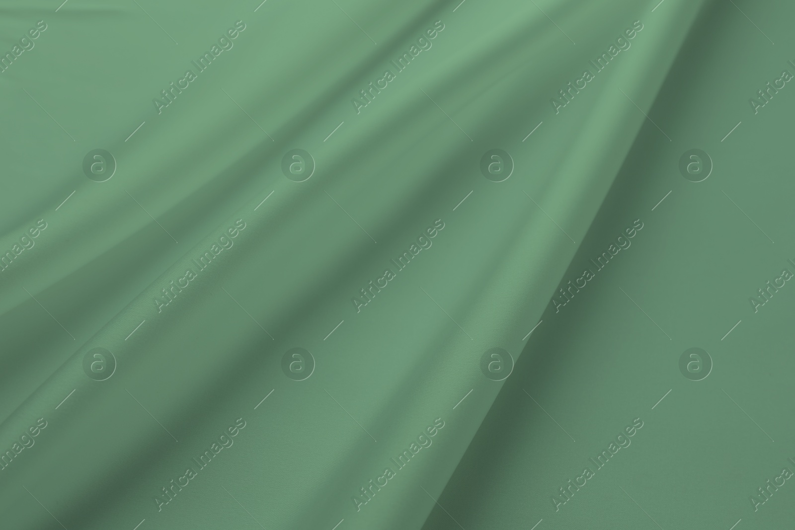 Image of Crumpled sage color silk fabric as background, top view