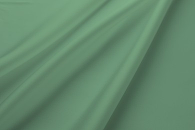 Image of Crumpled sage color silk fabric as background, top view