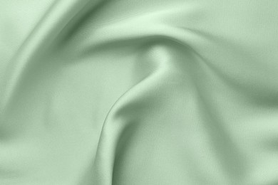 Image of Crumpled sage color silk fabric as background, top view