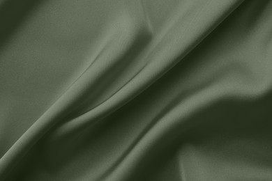 Image of Crumpled sage color silk fabric as background, top view