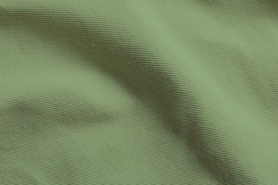 Sage color fabric as background, top view