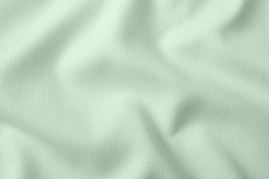 Sage color fabric as background, top view