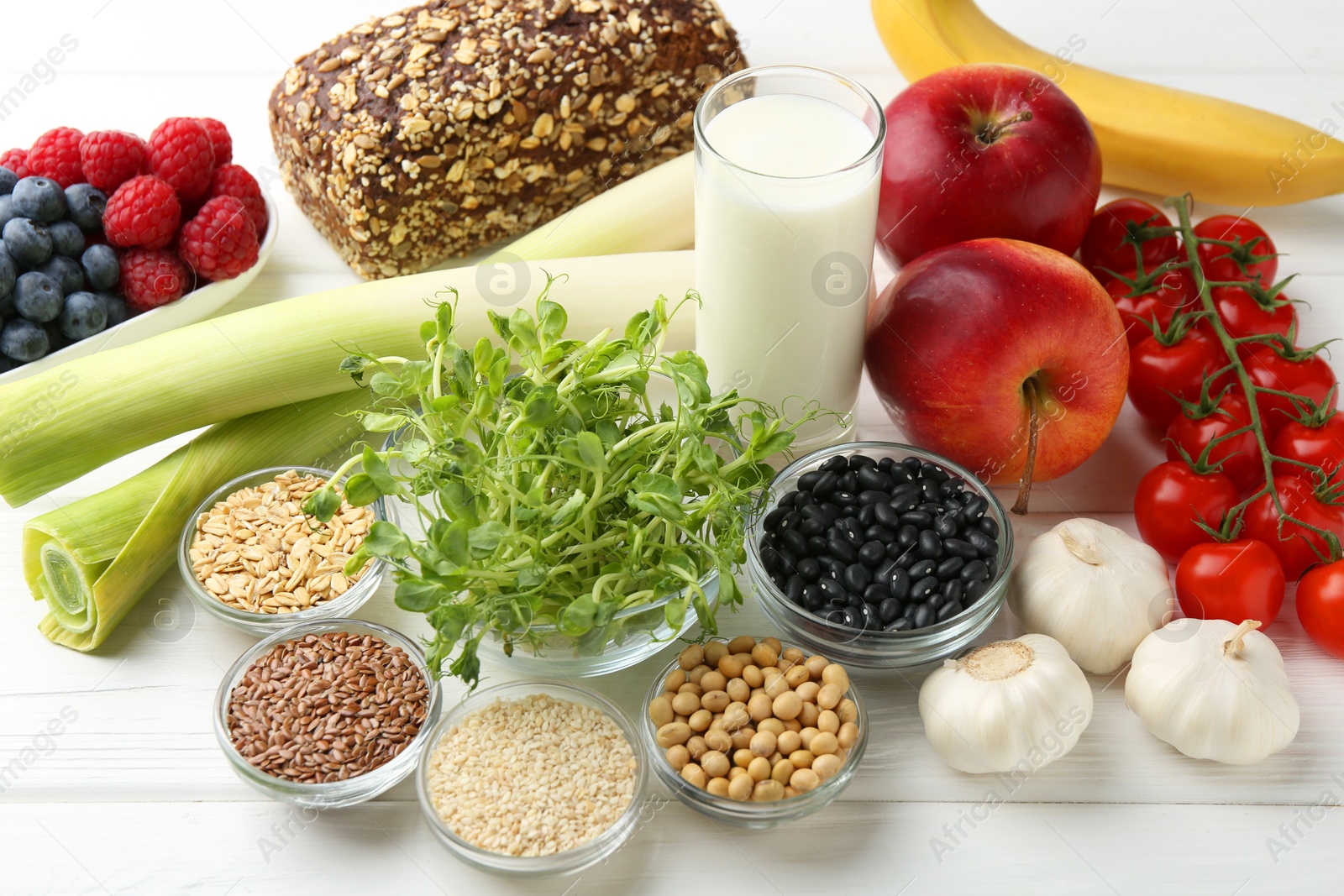 Photo of Different fresh products on white wooden table. Source of prebiotics