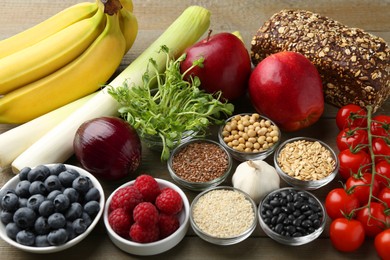 Photo of Different fresh products on wooden table. Source of prebiotics