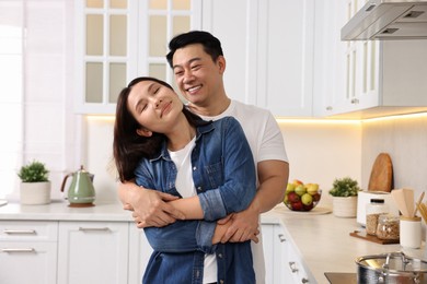 Lovely couple enjoying time together while cooking in kitchen