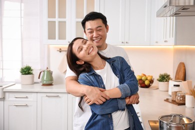 Lovely couple enjoying time together while cooking in kitchen