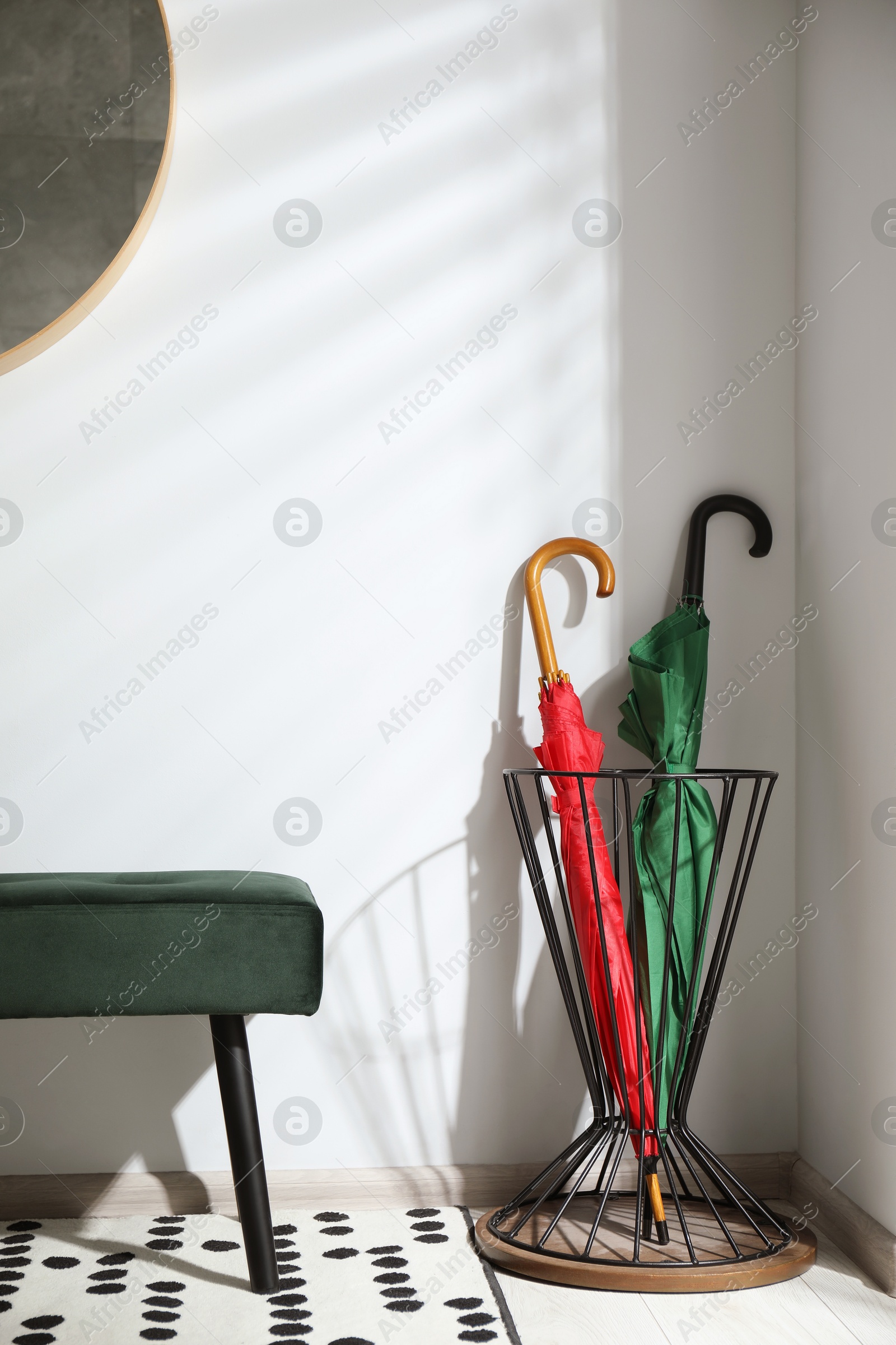 Photo of Colorful umbrellas in stand near light wall