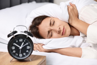 Photo of Sleepy woman in bed at lunch time