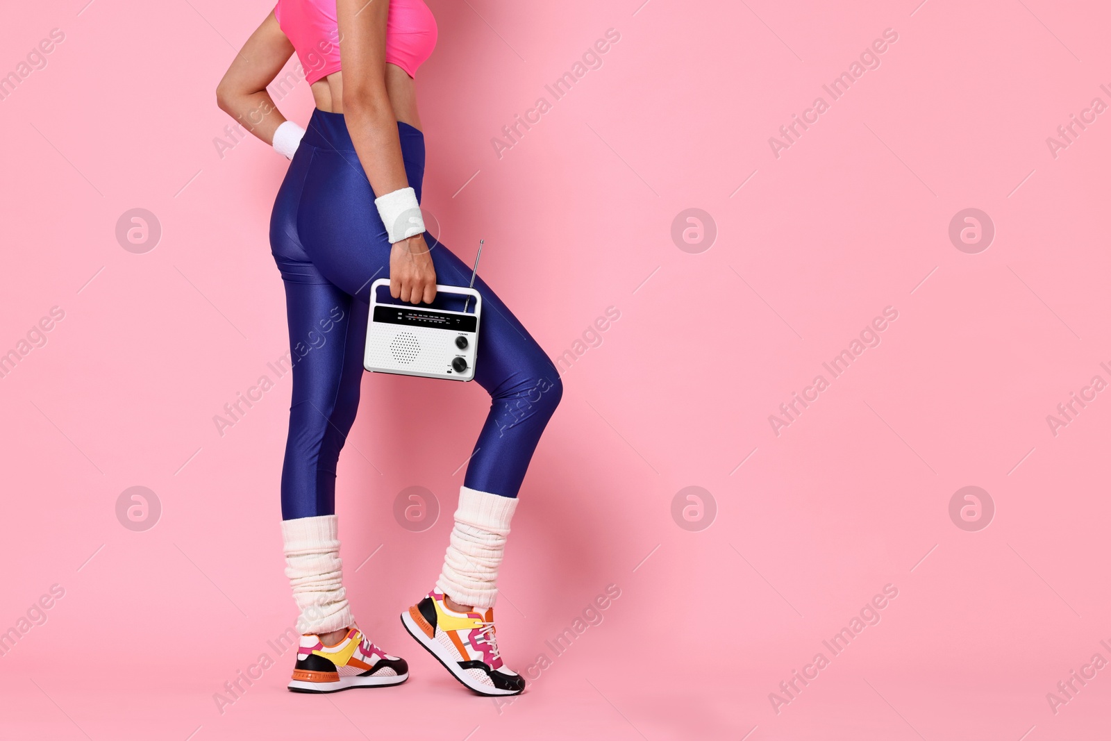 Photo of Aerobics. Woman with radio receiver on pink background, closeup. Space for text