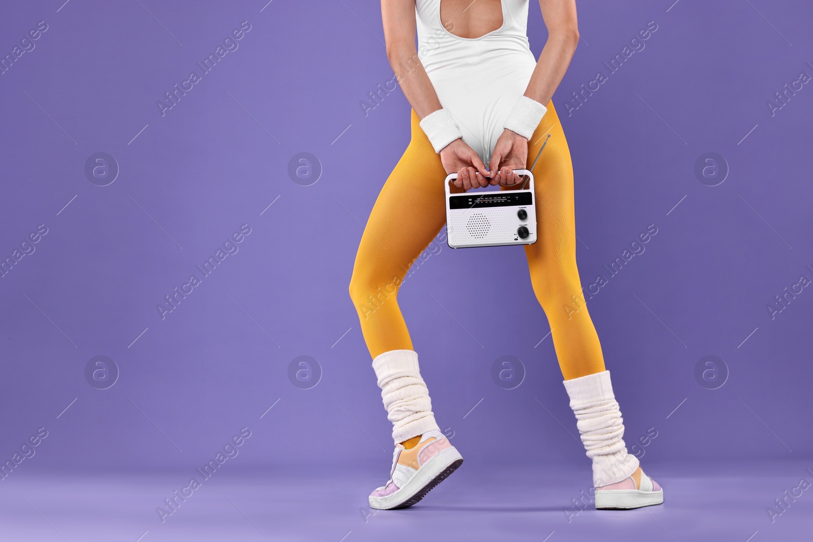 Photo of Aerobics. Woman with radio receiver on purple background, closeup. Space for text