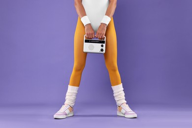 Photo of Aerobics. Woman with radio receiver on purple background, closeup