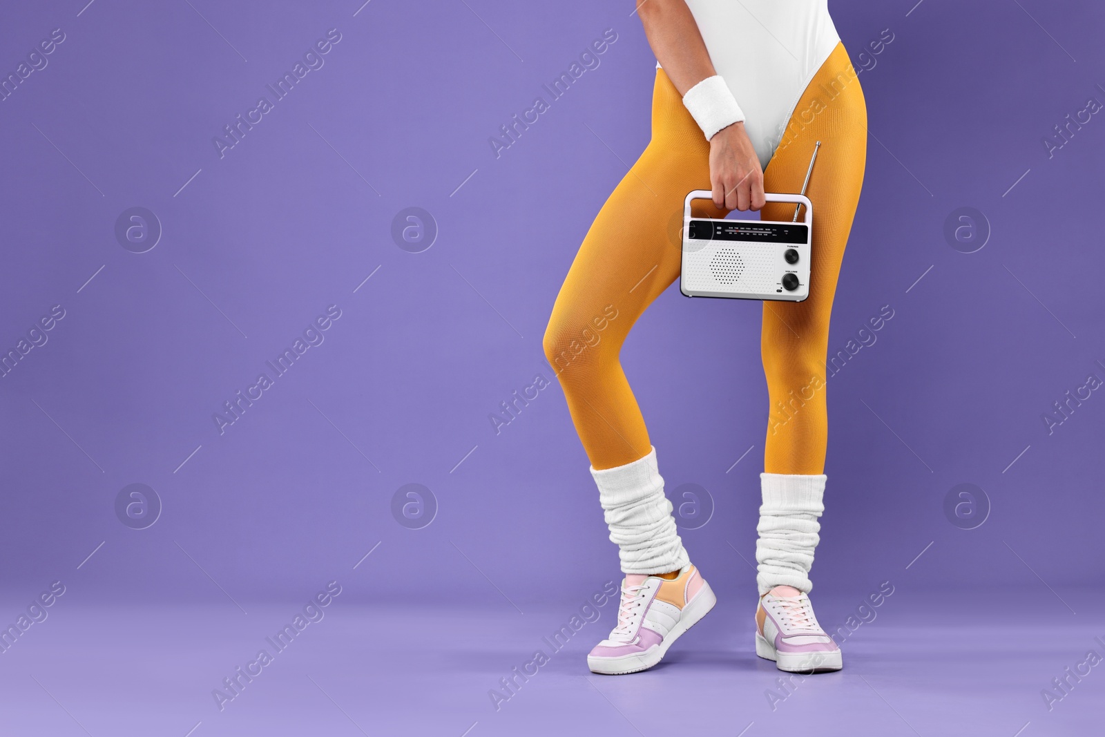 Photo of Aerobics. Woman with radio receiver on purple background, closeup. Space for text