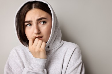 Portrait of scared woman on light background