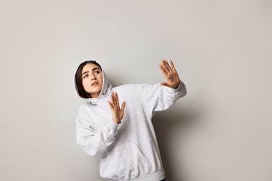 Photo of Portrait of scared woman on light background