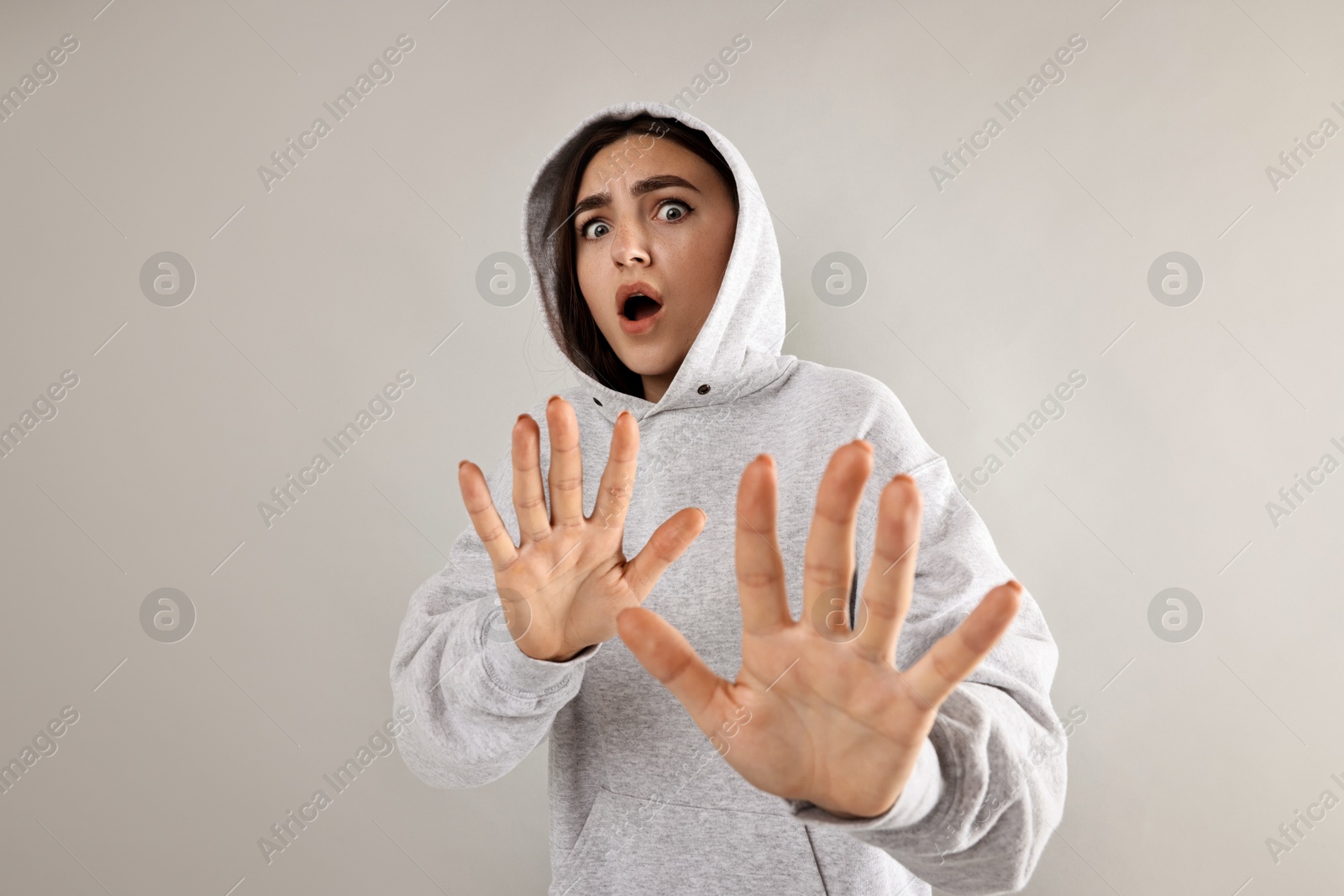 Photo of Portrait of scared woman on light background