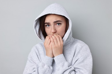 Photo of Portrait of scared woman on light background