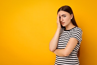 Photo of Portrait of scared woman on orange background. Space for text