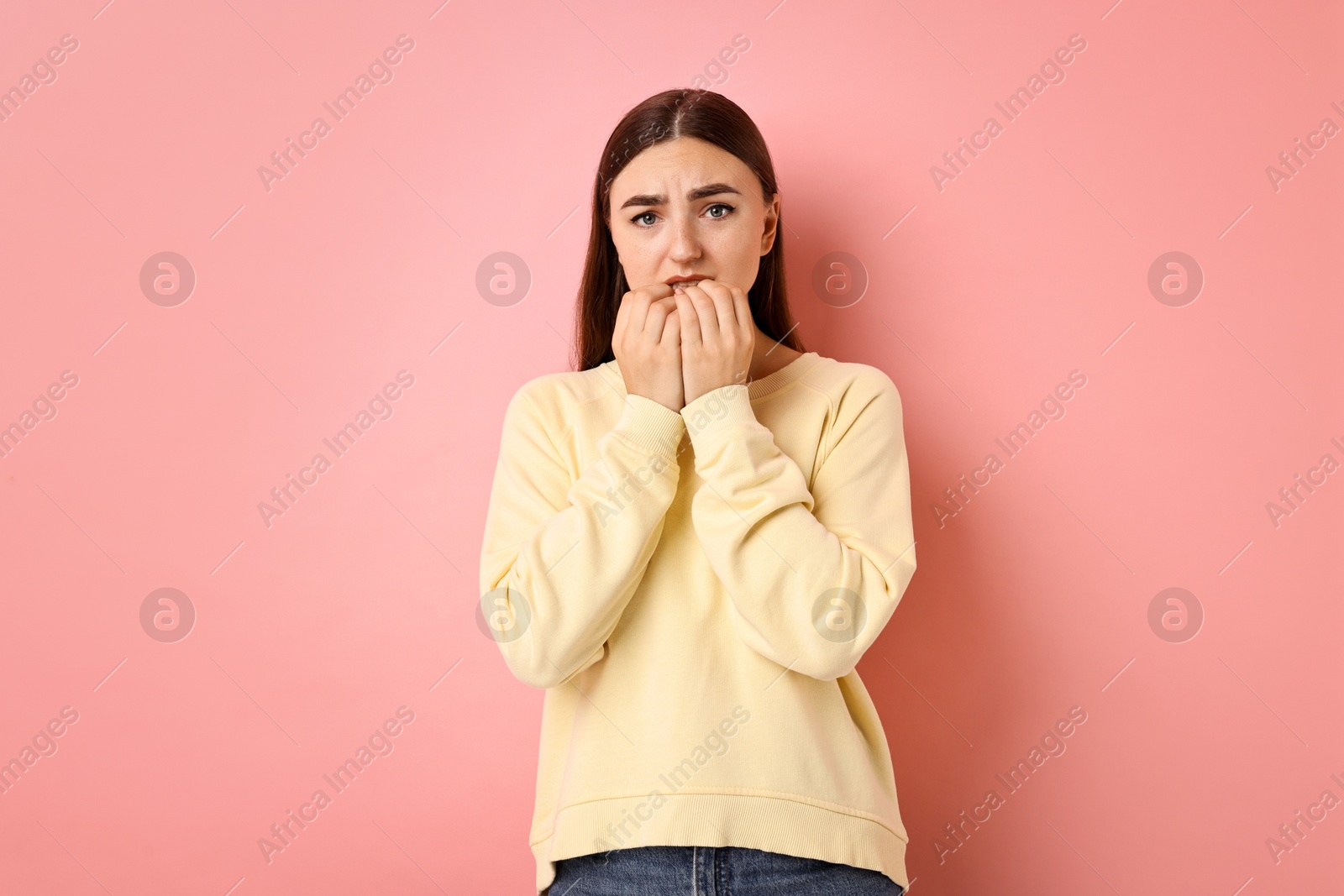 Photo of Portrait of scared woman on pink background