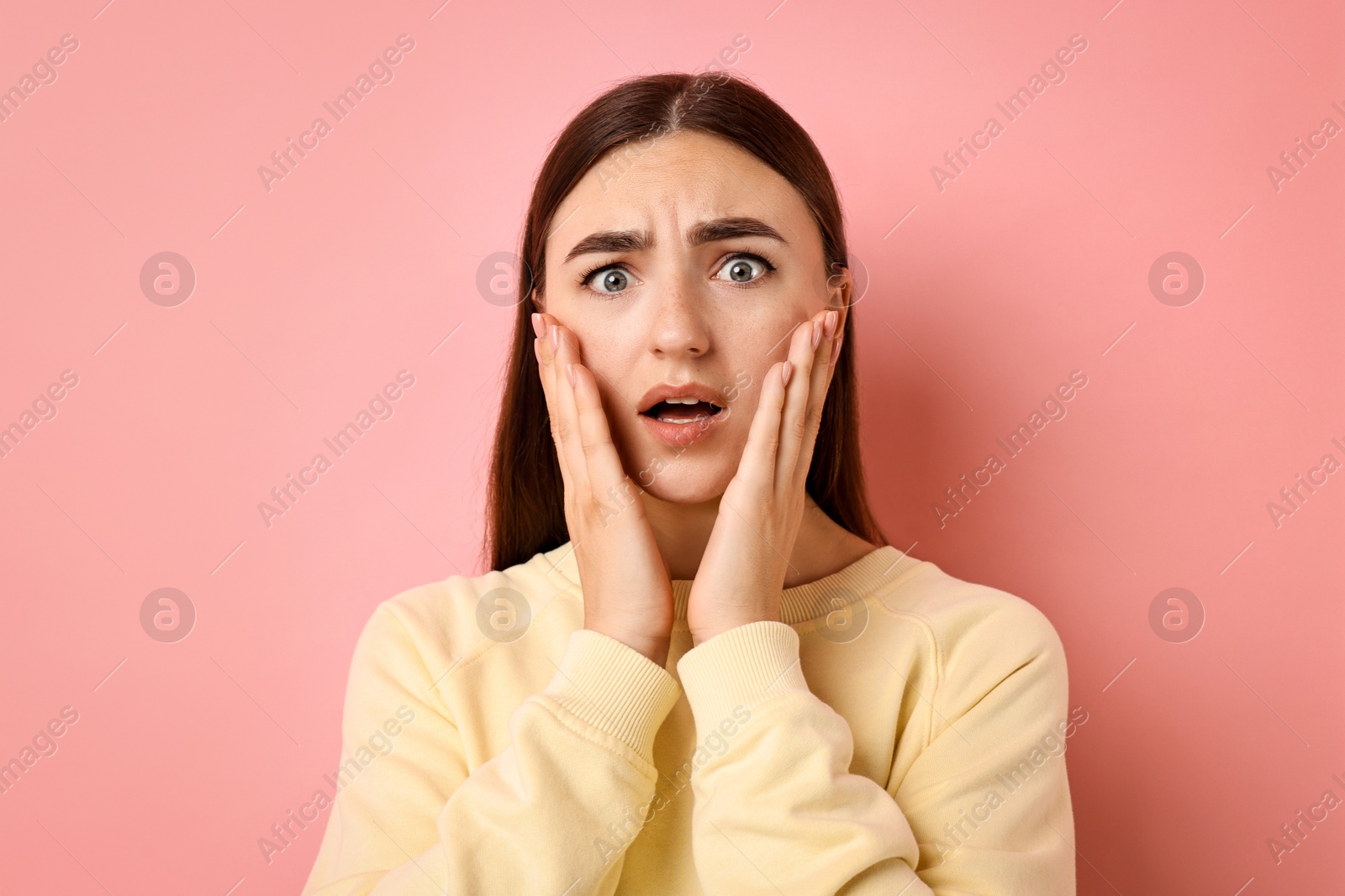 Photo of Portrait of scared woman on pink background