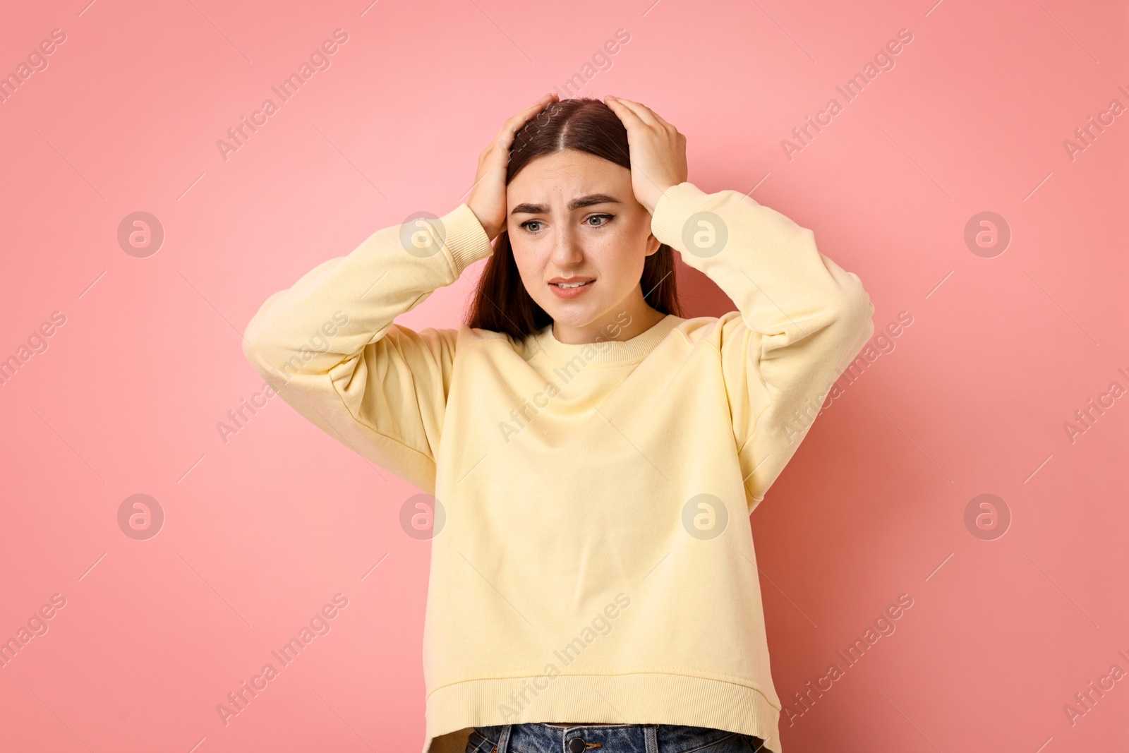 Photo of Portrait of scared woman on pink background