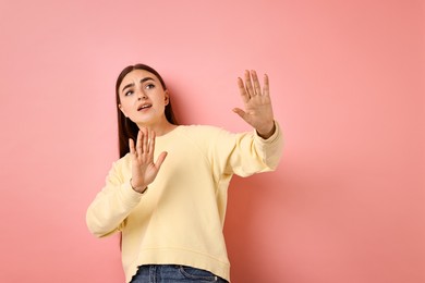 Photo of Portrait of scared woman on pink background