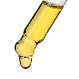 Photo of Dripping essential oil from pipette on white background