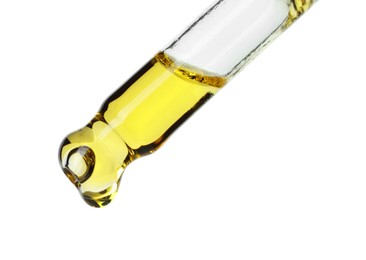 Photo of Dripping essential oil from pipette on white background