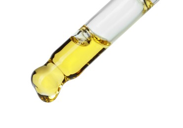 Photo of Dripping essential oil from pipette on white background