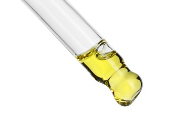 Photo of Dripping essential oil from pipette on white background