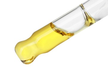 Photo of Dripping essential oil from pipette on white background