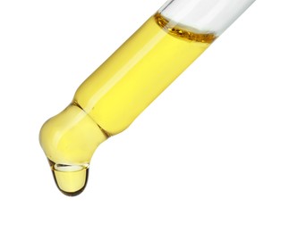 Photo of Dripping essential oil from pipette on white background