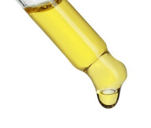 Photo of Dripping essential oil from pipette on white background