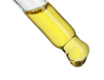 Photo of Dripping essential oil from pipette on white background