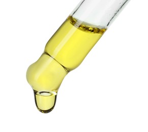 Dripping essential oil from pipette on white background