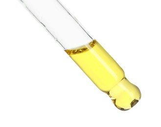 Photo of Dripping essential oil from pipette on white background