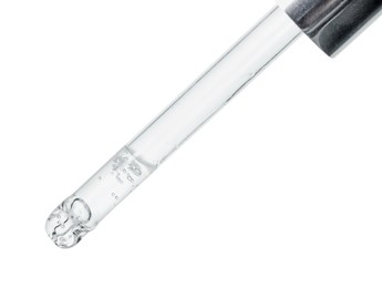 Dripping cosmetic serum from pipette on white background