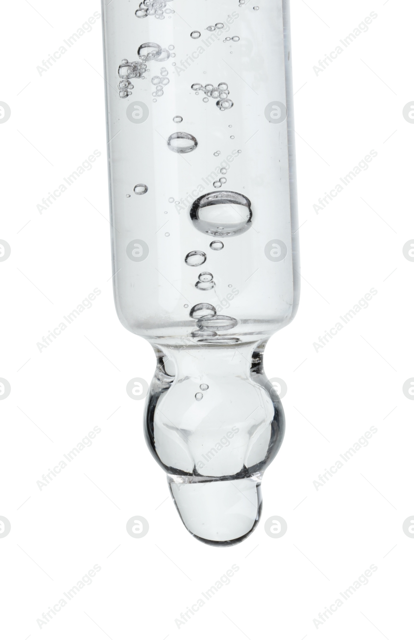 Photo of Dripping cosmetic serum from pipette on white background