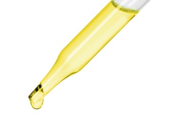 Photo of Dripping essential oil from pipette on white background