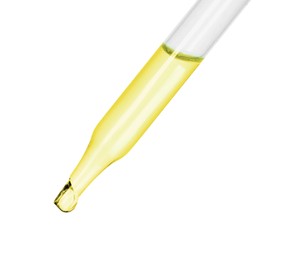 Dripping essential oil from pipette on white background