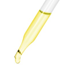 Photo of Dripping essential oil from pipette on white background