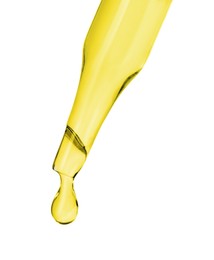 Photo of Dripping essential oil from pipette on white background