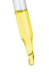 Photo of Dripping essential oil from pipette on white background