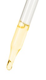 Dripping essential oil from pipette on white background